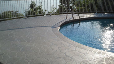 This image shows a stamped concrete pool deck
