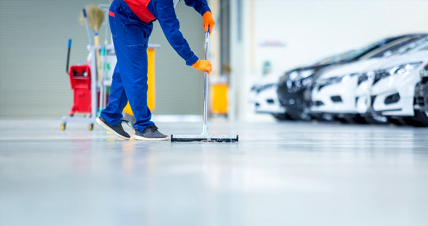 This image shows a man cleaning the floor.