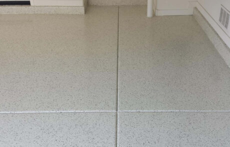 This image shows a garage with a flake epoxy floor.