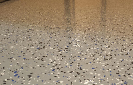 This image shows black,white and blue flake epoxy floor.