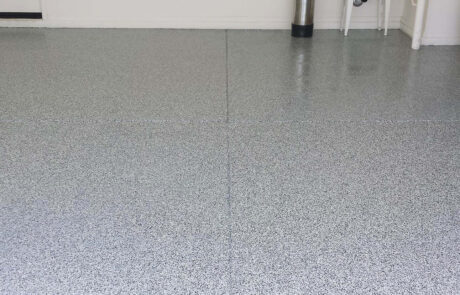 This image shows a garage with a flake epoxy floor.