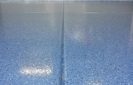 This image shows a garage with a flake epoxy floor.