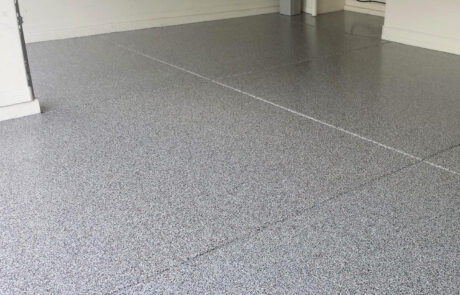 This image shows a garage with a flake epoxy floor.