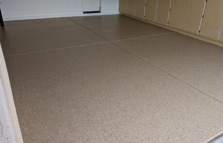This image shows a garage with a flake epoxy floor.
