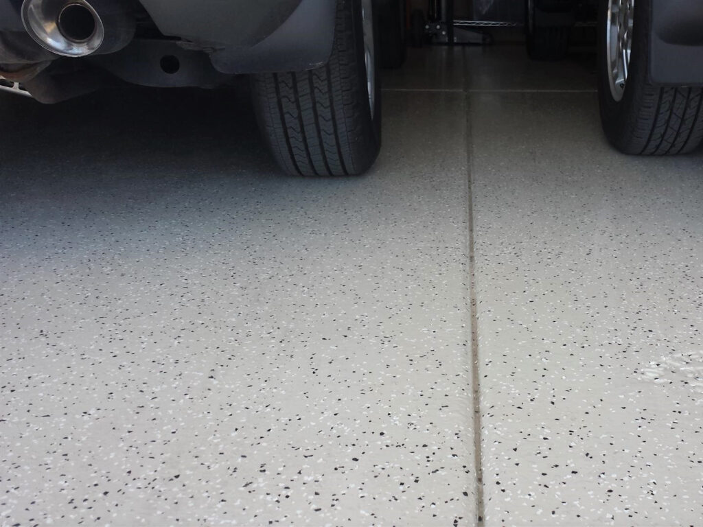 This image shows a garage with a flake epoxy floor.