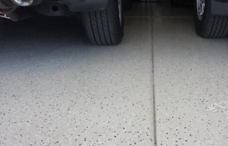 This image shows a garage with a flake epoxy floor.