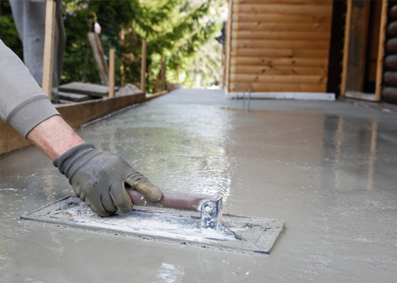 This image shows a man levelling a cement floor.