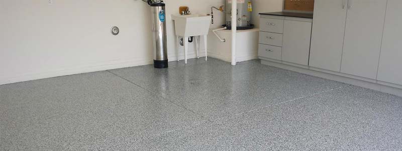 This image shows a garage witch was painted with epoxy flake floor.