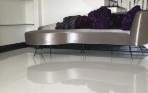 This image shows a living room floor that has a white epoxy floor.