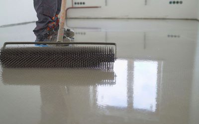This image shows a man applying epoxy paint on a floor.