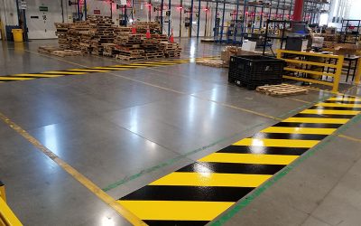 This image shows a commeercial floor with yeellow and black epoxy paint.