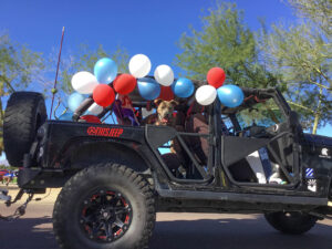 This image shows a dog and baloons on a jeep in Sun City Grand, Surprise Arizona