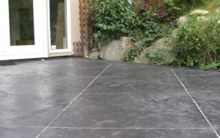 This image shows a patio floor with concrete decorative overlay.