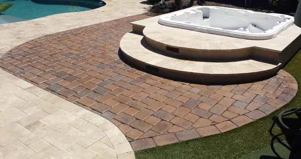 This image shows a pool deck made up of pavers