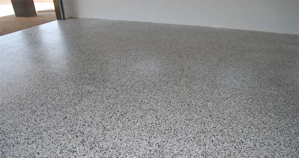 This image shows a garage floor with epoxy flake floor