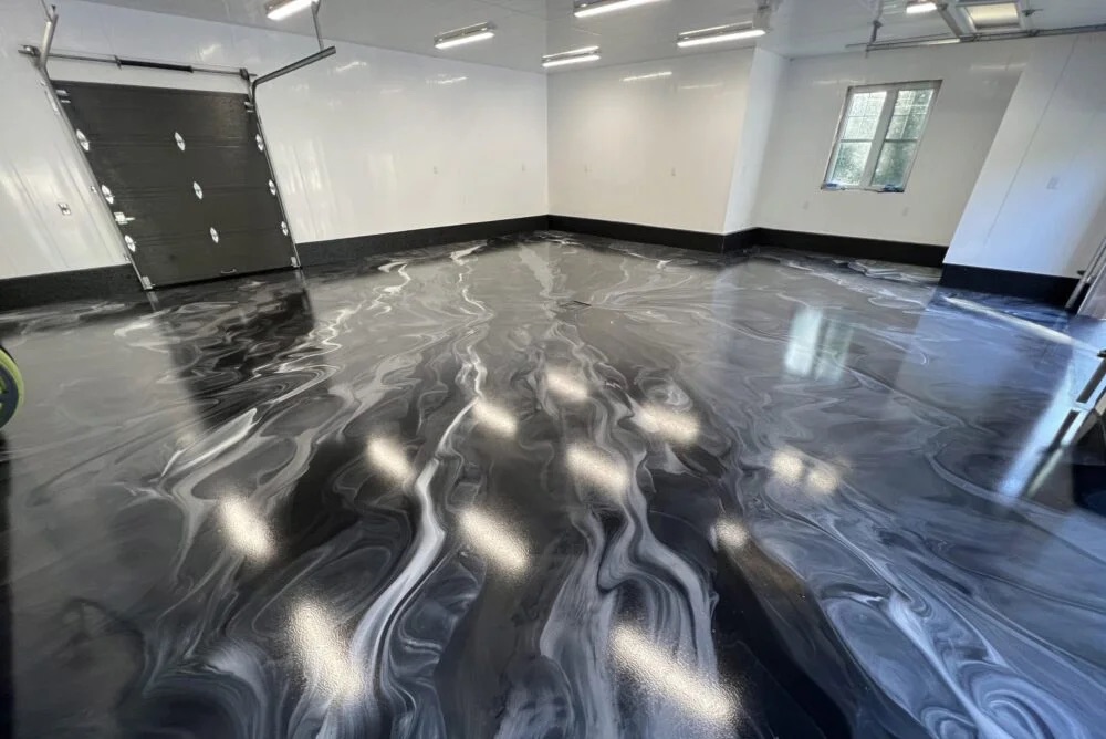 11. metallic epoxy maintenance This image shows a driveway that was painted with epoxy