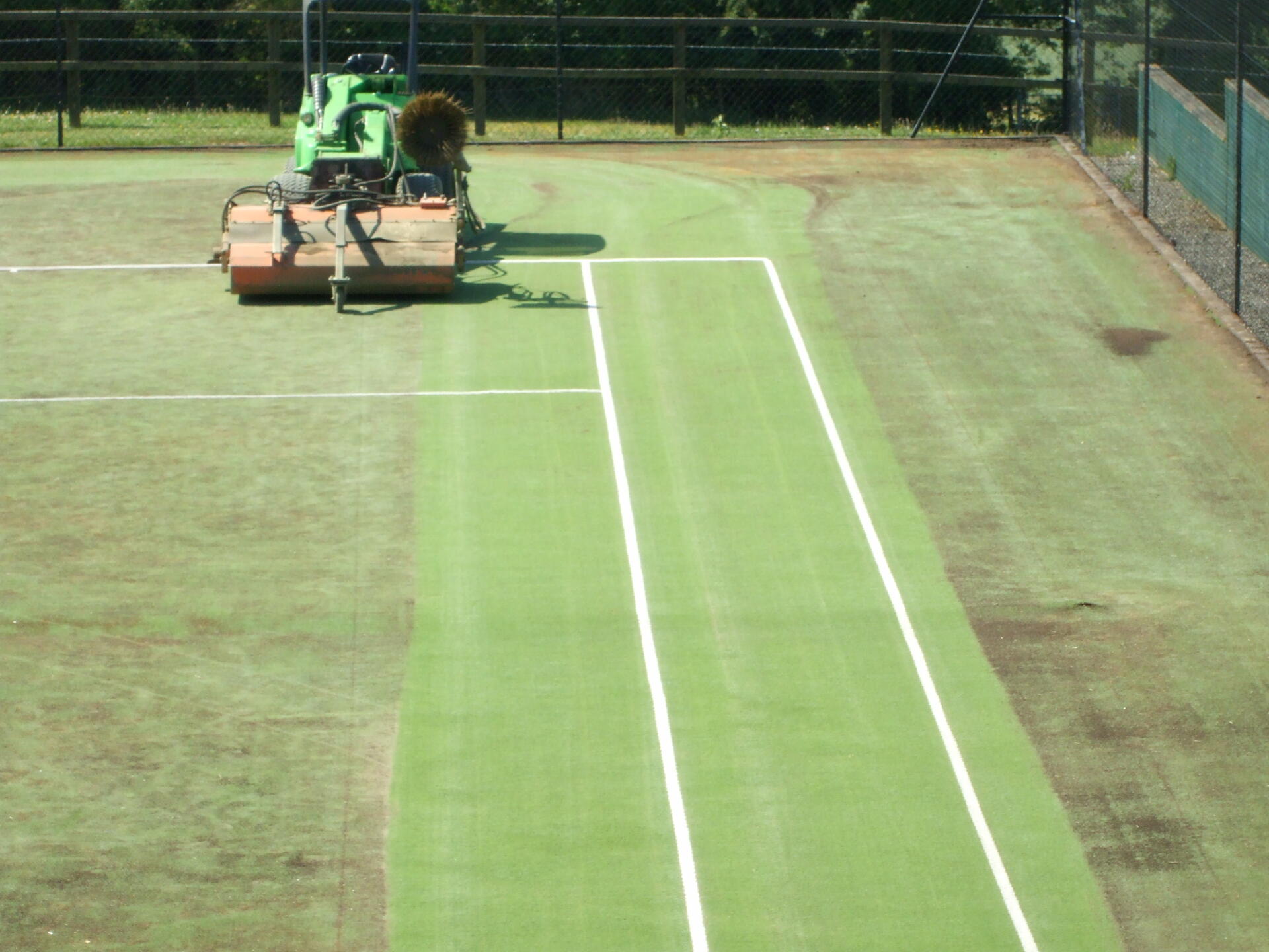 7. tennis court resurfacing maintenance This image shows a driveway that was painted with epoxy