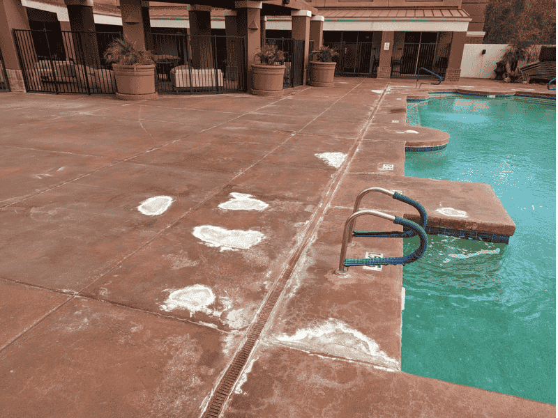 This image shows a pool deck that is being repaired.