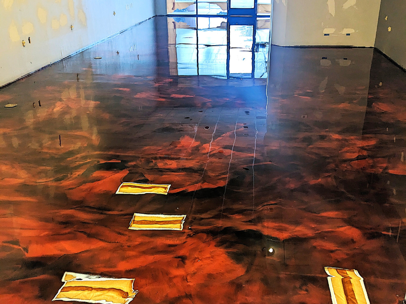 Metallic epoxy floor This image shows a pool deck made up of pavers