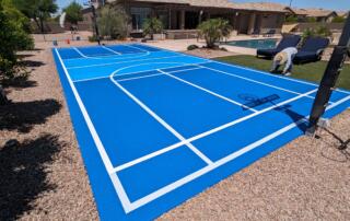 Light blue sport court surface reflecting heat in Arizona