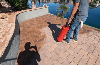 sealing pavers This image shows a man sealing pavers in Arizona