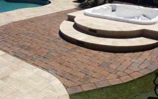 Stone pavers beside a pool where hard water staining occurs